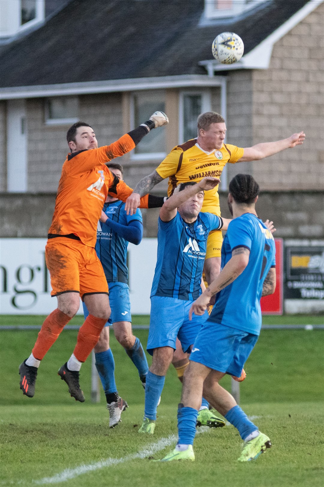 Strathspey Thistle goalkeeper Michael MacCallum punches clear of Forres' Lee Fraser. Picture: Daniel Forsyth.
