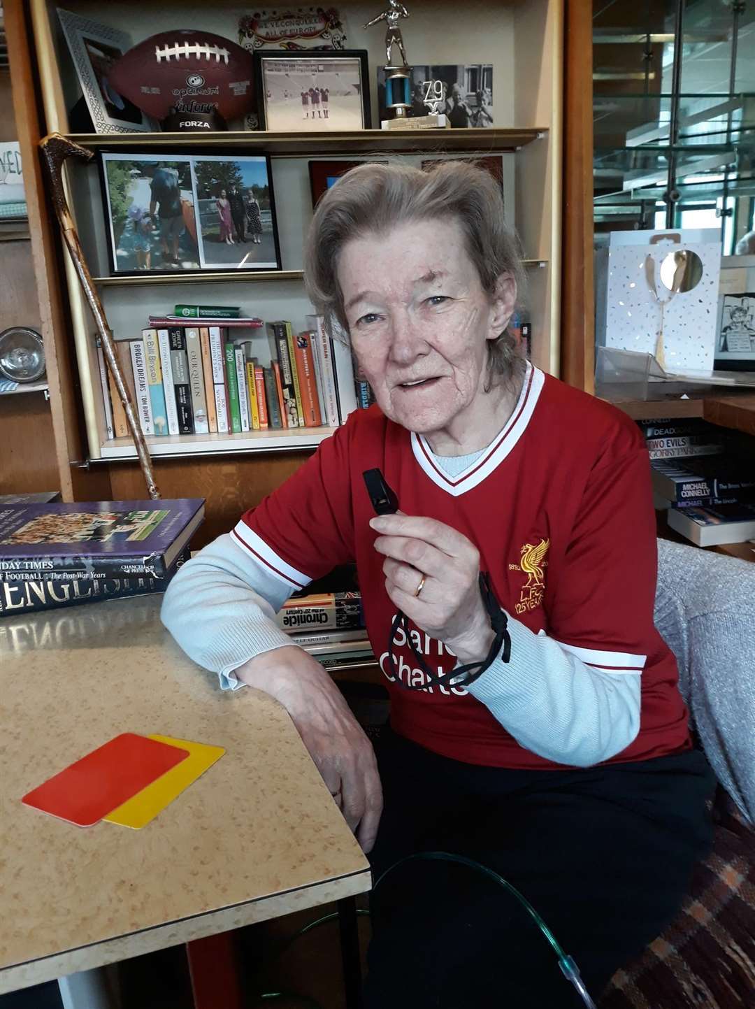 Lyn in her favourite Liverpool strip, with her favourite old whistle - and those indispensable cards!