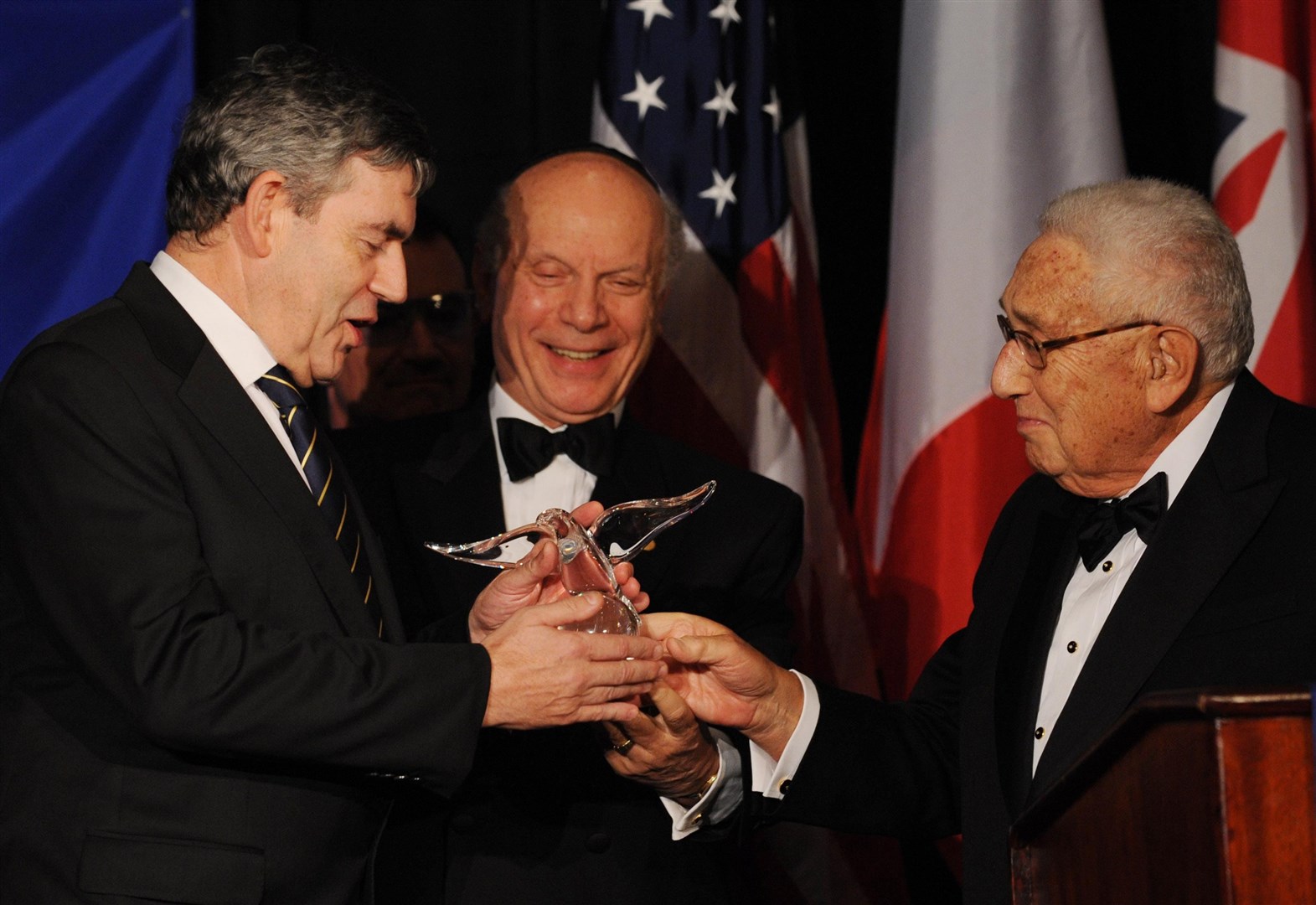 Then-prime minister Gordon Brown receiving an award from Mr Kissinger in New York in September 2009 (PA)