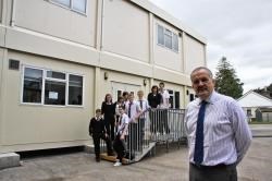 Deputy head Brian Ross and pupils by the temporary classrooms which will be in use whilst the school is being extended