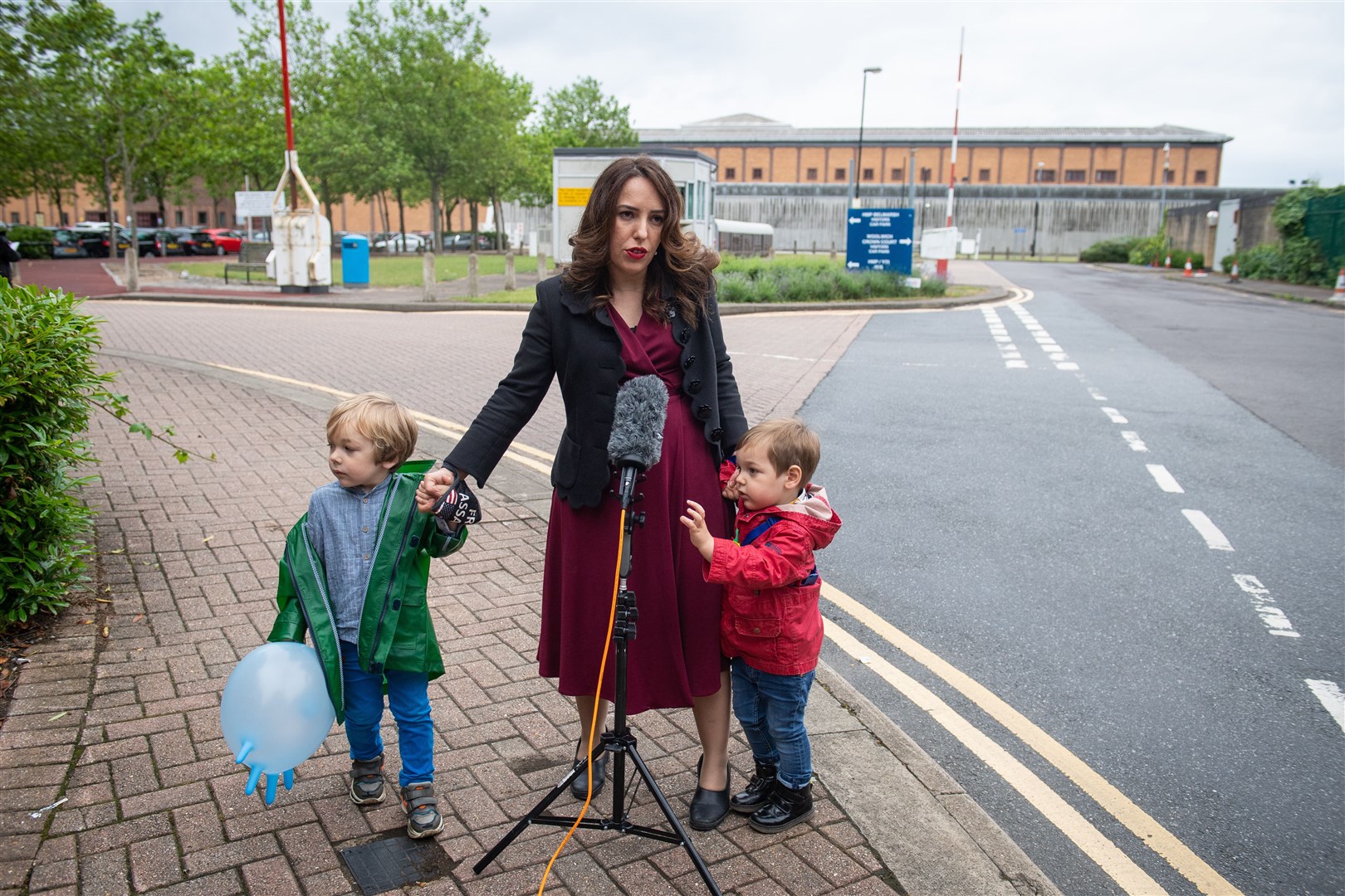 Stella Moris stands with her children Gabriel and Max as she speaks to the media outside Belmarsh Prison, London, following a visit to her partner and their father Julian Assange (Dominic Lipinski/PA)