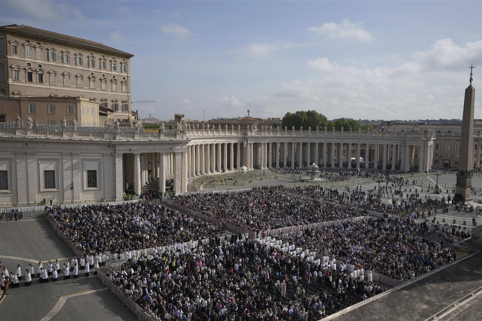 People gather in St Peter’s Square as they await the arrival of the body of Pope Francis (Markus Schreiber/AP)