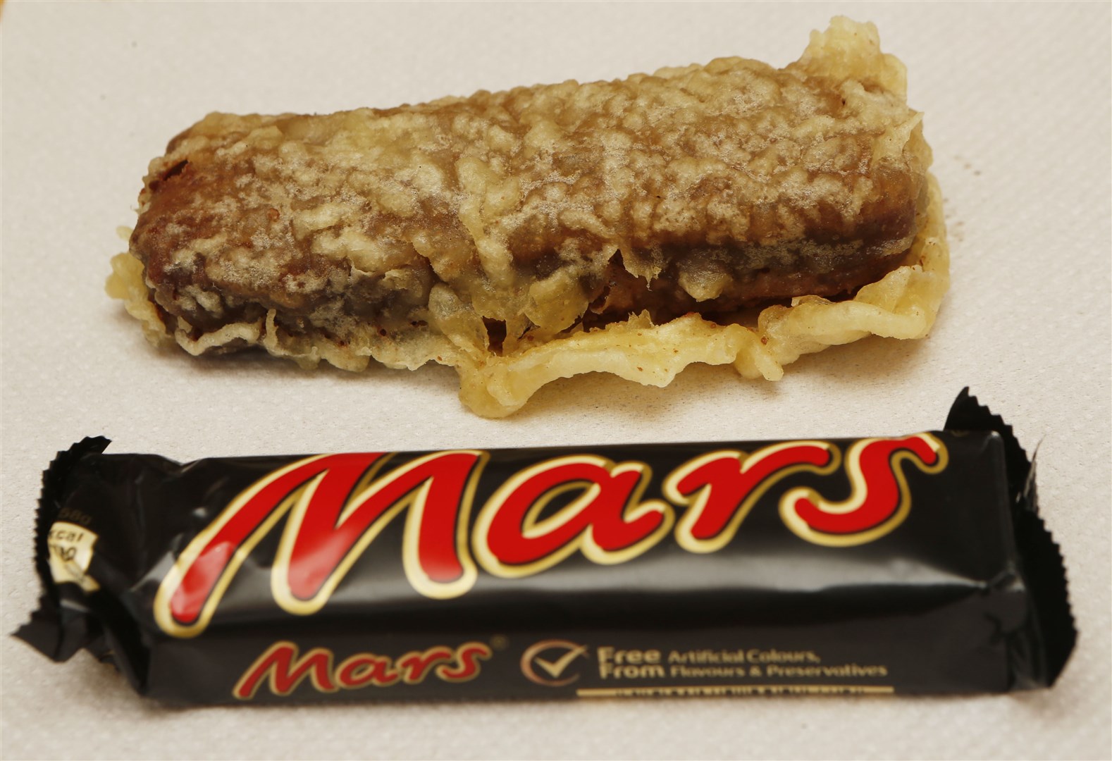A deep fried Mars bar is prepared in a Glasgow chip shop ahead of the Glasgow 2014 Commonwealth Games (Danny Lawson/PA)