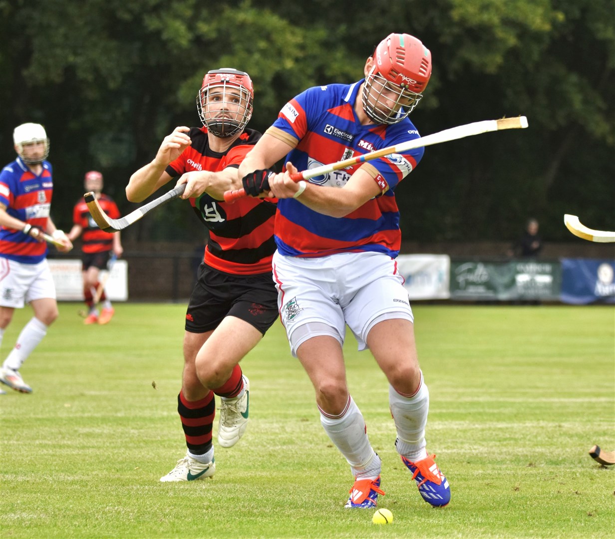The Kings' Alexander Michie gets to the ball ahead of Oban Camanachd's Daniel MacVicar.
