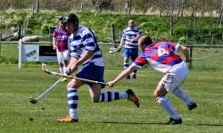 Newtonmore's Calum Stewart gets the better of the King's Barrie Dallas