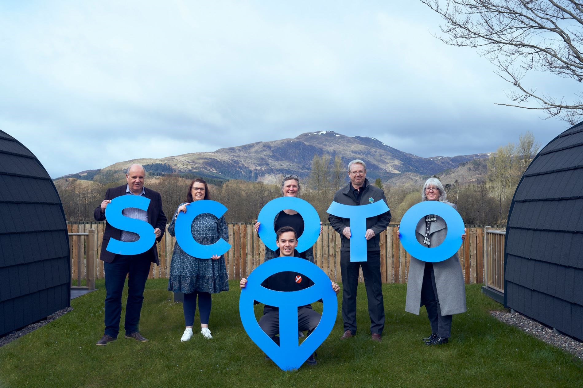 Left to right (back): Marc Crothall, chief executive of Scottish Tourism Alliance; Patricia Kent, manager at SCOTO member Callander Youth Project Trust; SCOTO facilitator Carron Tobin; SCOTO chairman Russell Fraser of Loch Ness Hub; Diane Smith, SCOTO coordinator. Front: Jack Wardrop, former Modern Apprentice and now youth worker with Callander Youth Project Trust with the SCOTO place-marker.