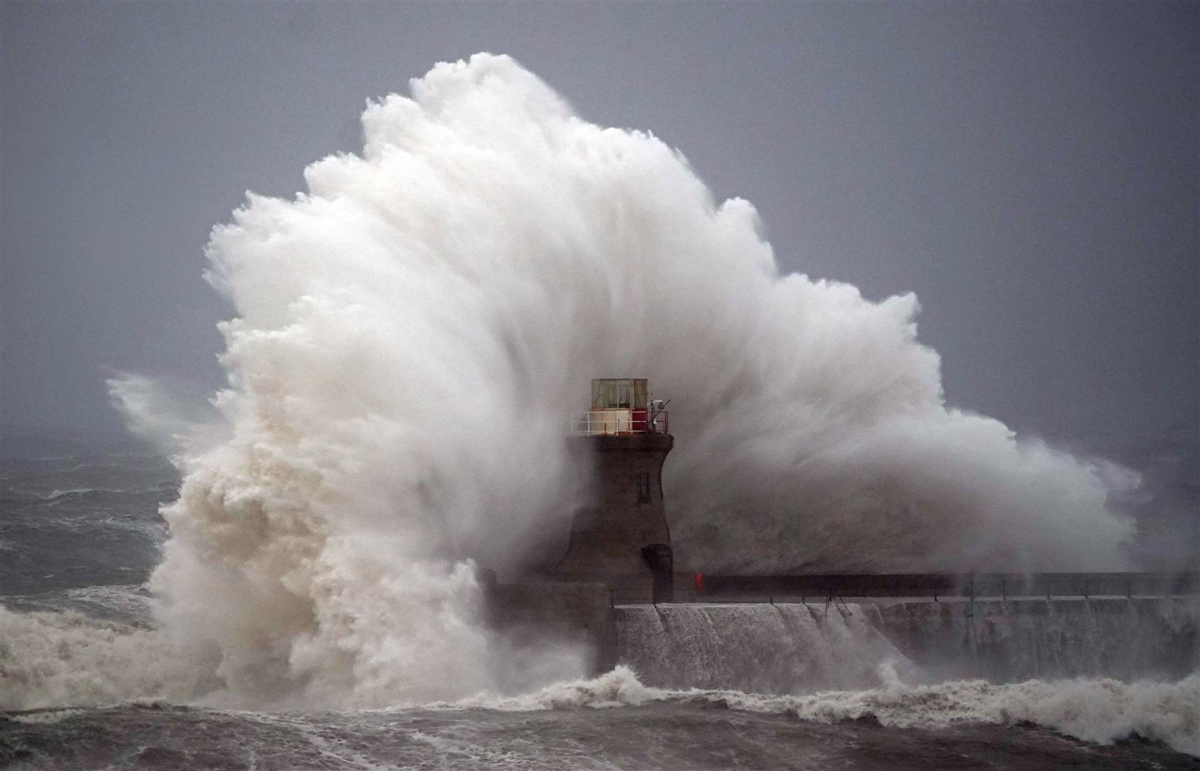 Waves crash against South Shields lighthouse on October 20 2023, after the top was ripped off during storm Babet (Owen Humphreys/PA)