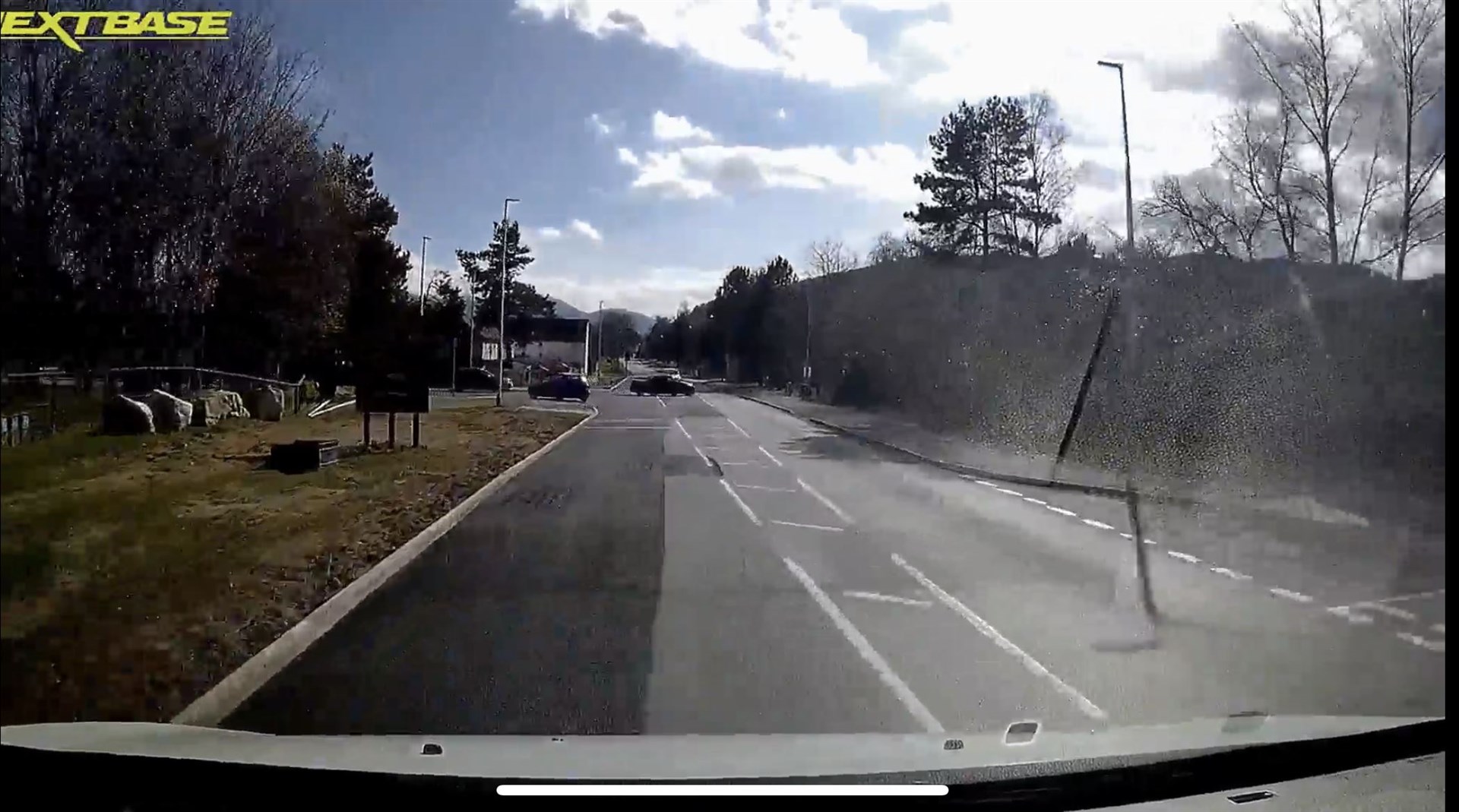 The motorist pulls out onto the wrong side of the road in front of the car at the new lane for traffic turning right into Dalfaber Drive.