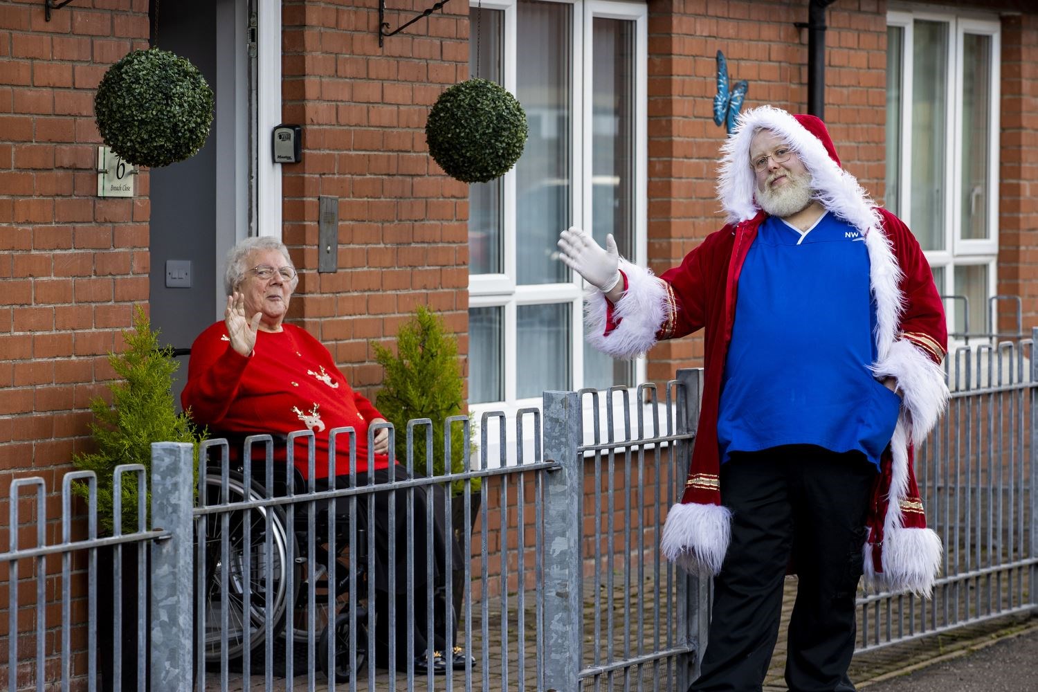 Care worker Robert Hillerby and one of his regular clients, Lucinda Quinn, outside her east Belfast home (Liam McBurney/PA)