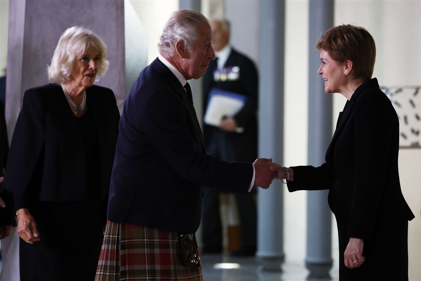 Charles and Camilla are greeted by First Minister of Scotland Nicola Sturgeon ahead of receiving a Motion of Condolence at the Scottish Parliament in Holyrood on D-Day +3 (Jeff J Mitchell/PA)