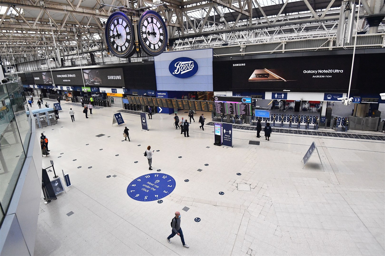 Commuters cross the concourse at London’s Waterloo Station on Friday morning (Victoria Jones/PA)