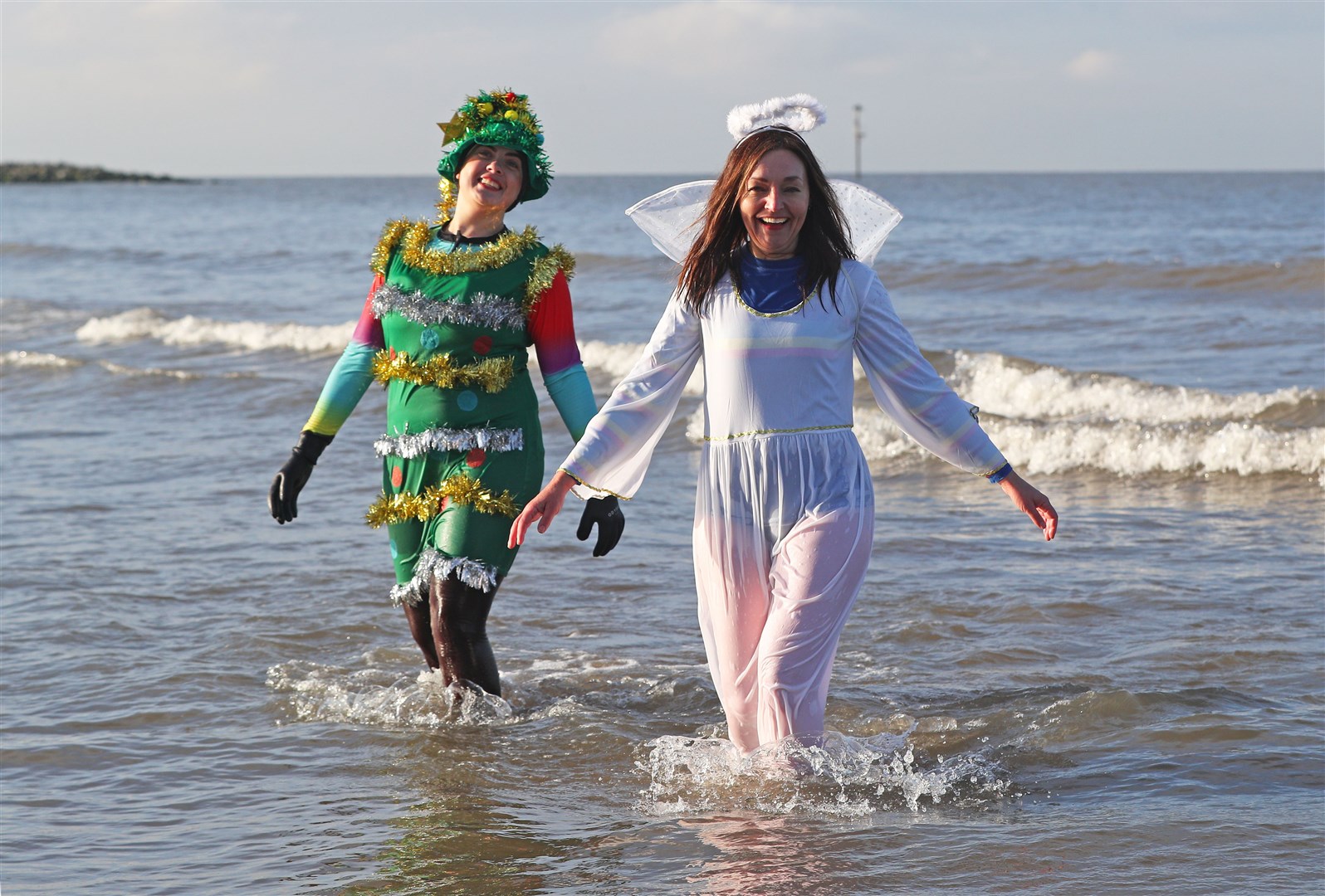 A festive fancy dress charity dip organised by Age UK in the sea at Leasowe on the Wirral (Peter Byrne/PA)