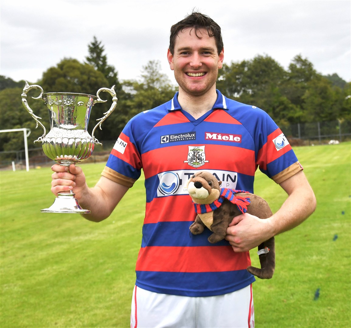Calum Grant shows off the Macaulay Cup accompanied by the Otter in memory of Calum Mackintosh. Pictures: Fiona Young.