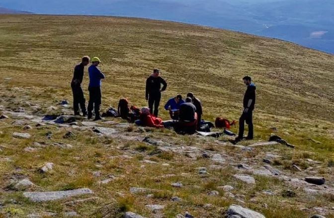 Members of the Cairngorm Mountain Rescue Team with the casualty.