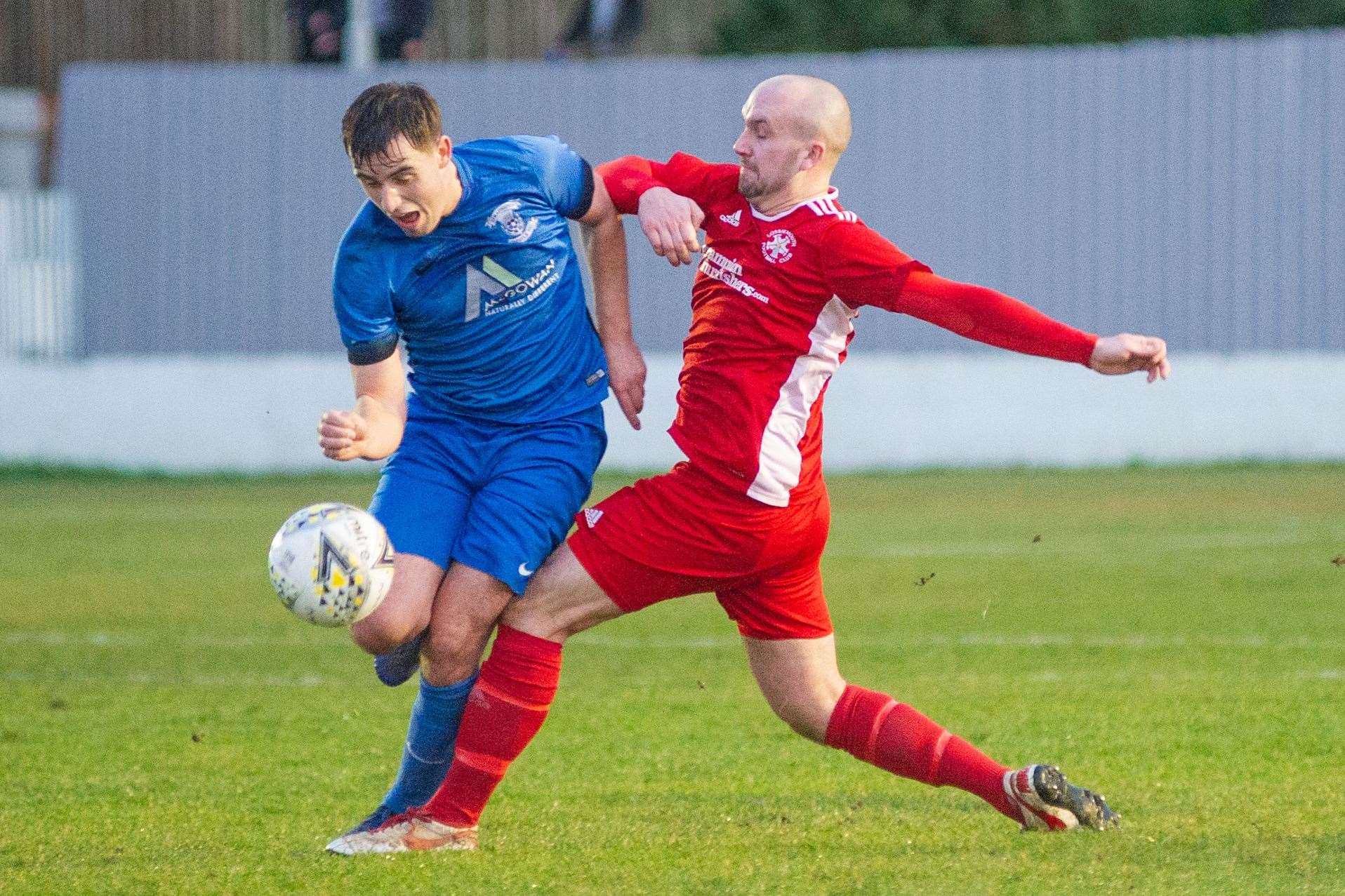 Lossiemouth FC's Connor Macaulay goes in for a solid challenge on the Jags' James McShane in Thistle's 2-0 win on January 4, 2020. Picture: Daniel Forsyth..