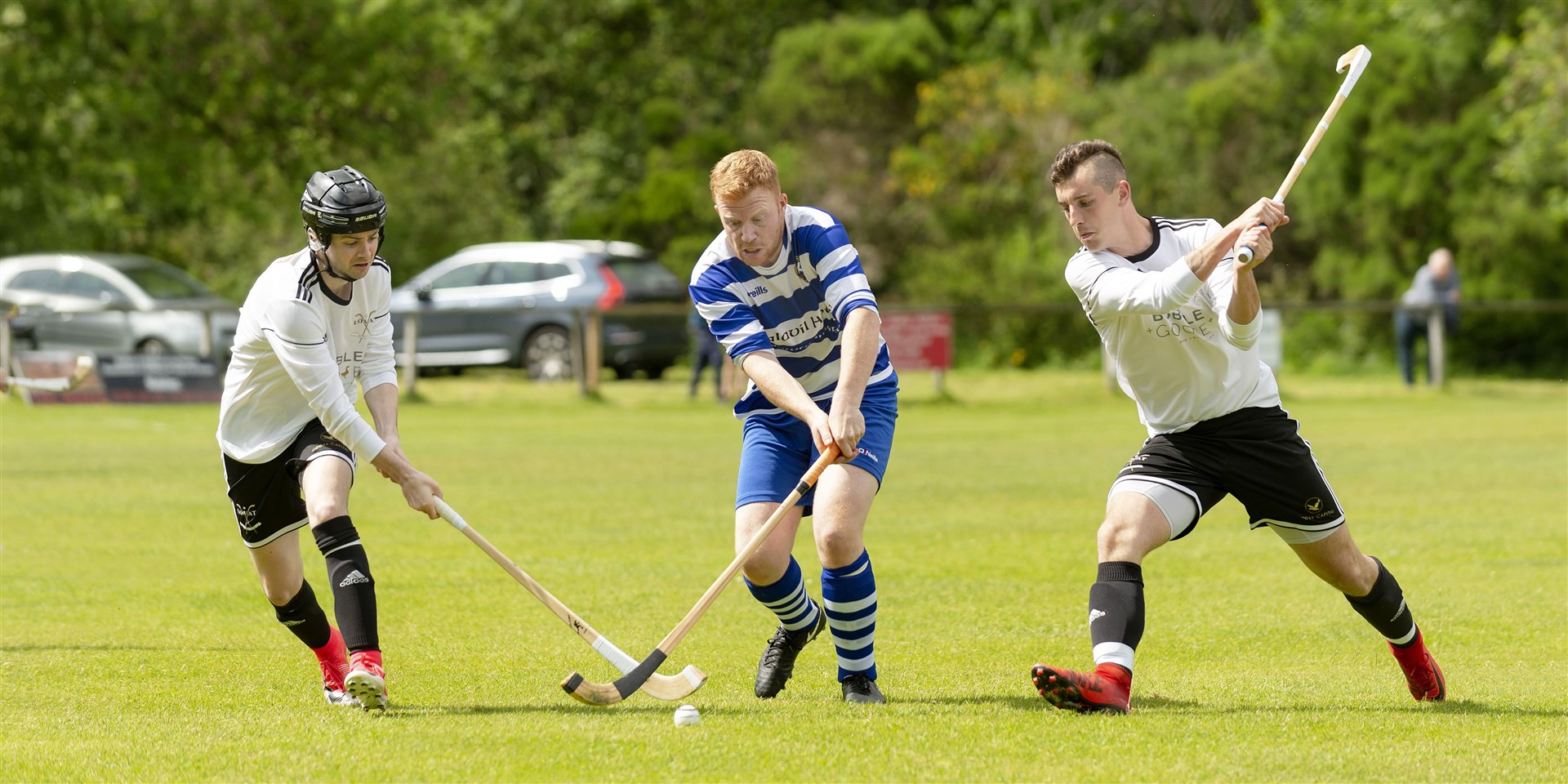 Lovat’s Calum MacAulay (left) and Lewis Tawse close down Owen Fraser (Newtonmore) in a Tulloch Homes Camanachd Cup second round replay.