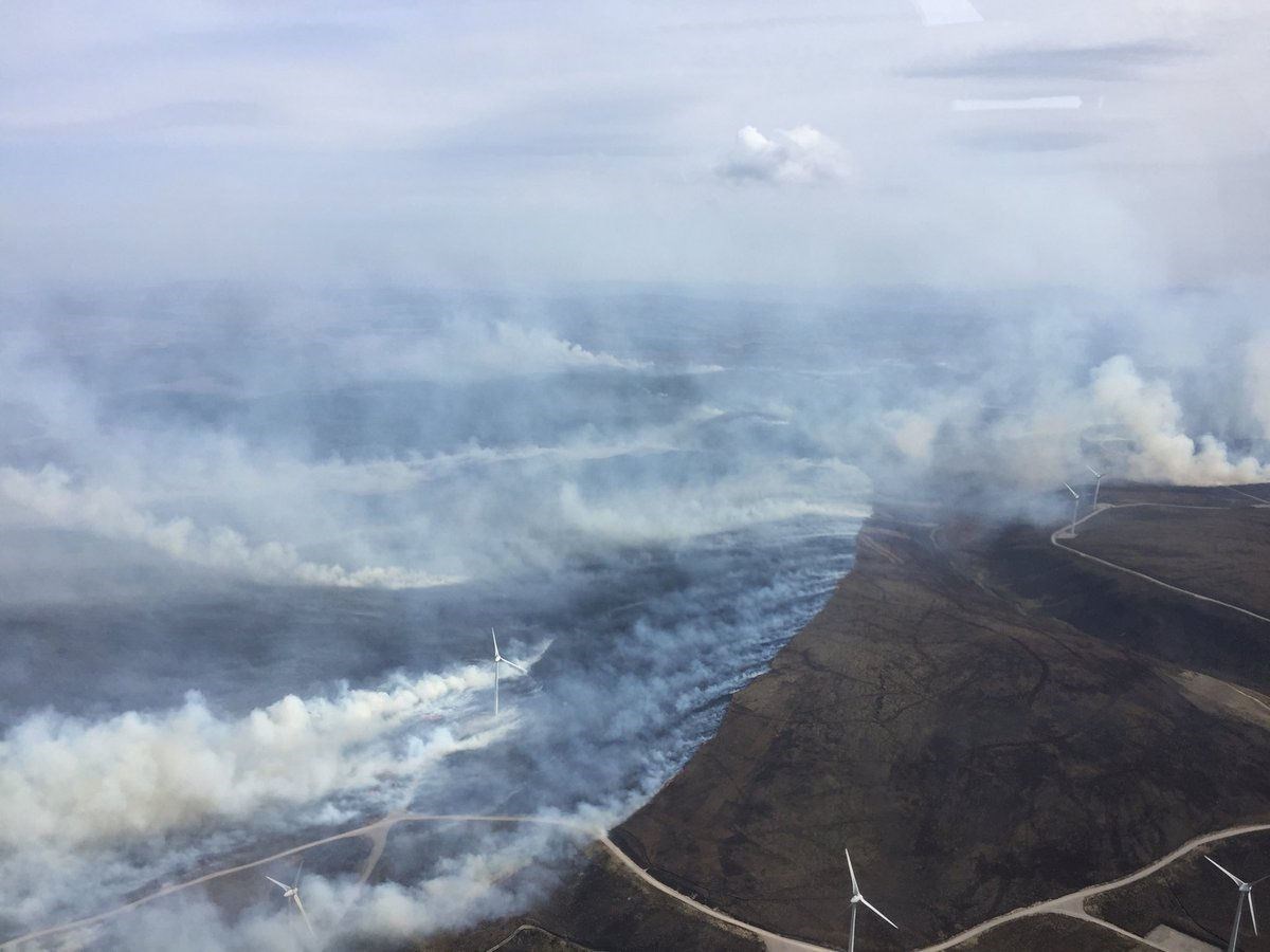 The wind farm tubines at the site can be seen amongst the smoke from the wildfire. (Photo: SFRS)