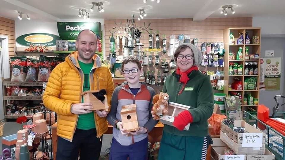 Xander (centre) with dad Ross and Iona Malcolm at the store.