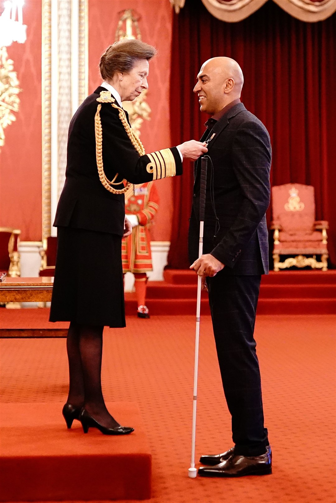 Amar Latif with the Princess Royal at Buckingham Palace (Aaron Chown/PA)