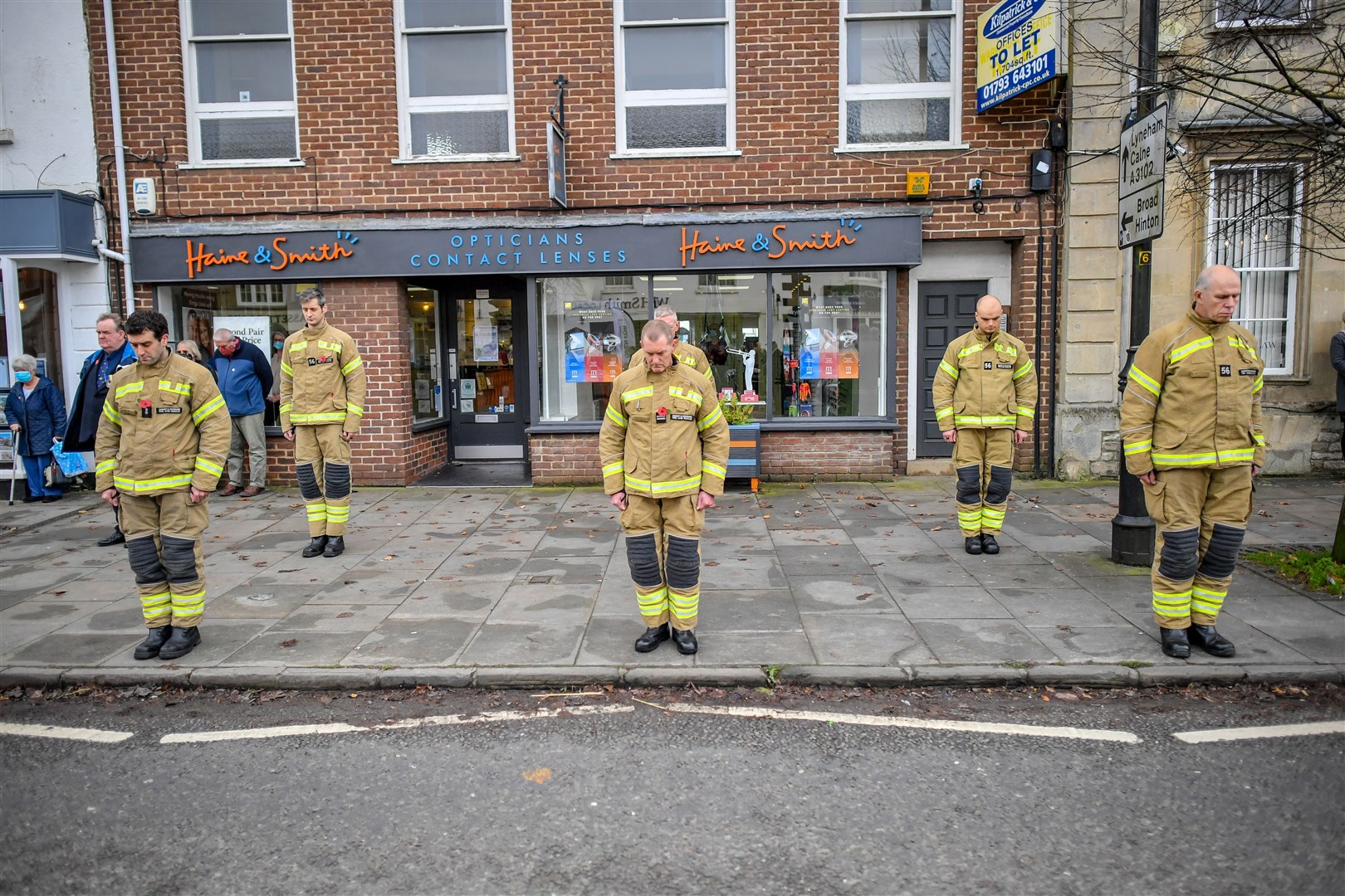 Firefighters parade opposite the war memorial in Royal Wootton Bassett (Ben Birchall/PA)