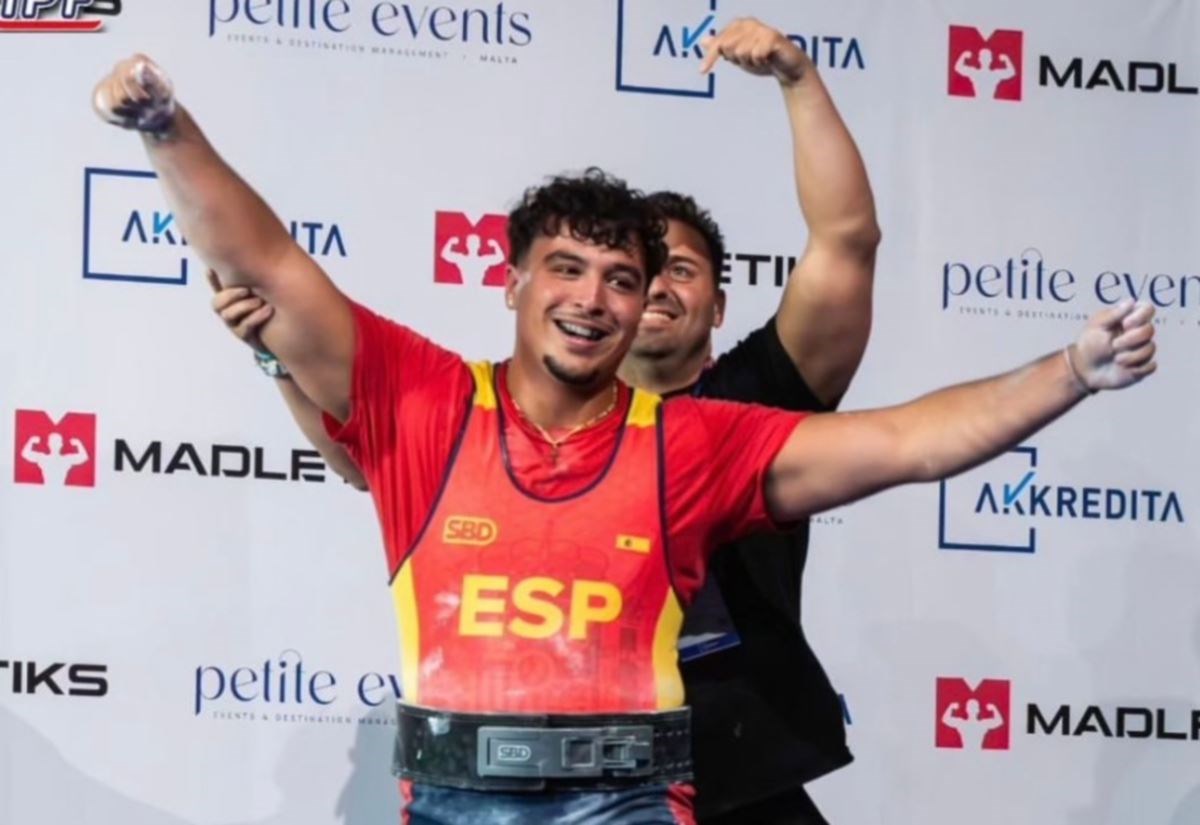 Joel celebrates becoming the new world champion in his division with Spanish team coach Daniel Torvisco.