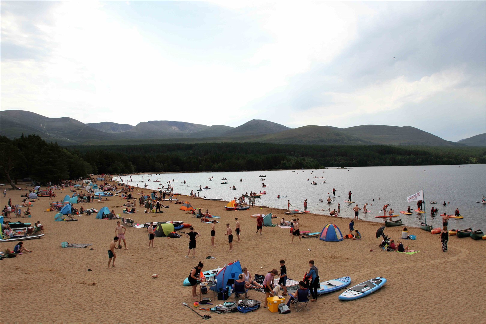 Beach goers gathered at Loch Morlich on Tuesday.