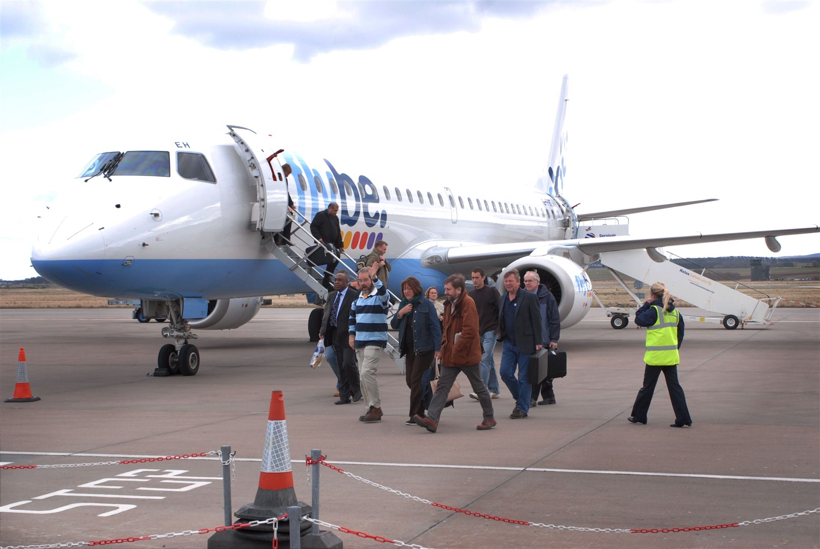 Passengers arrive at Inverness Airport on a a Flybe jet.