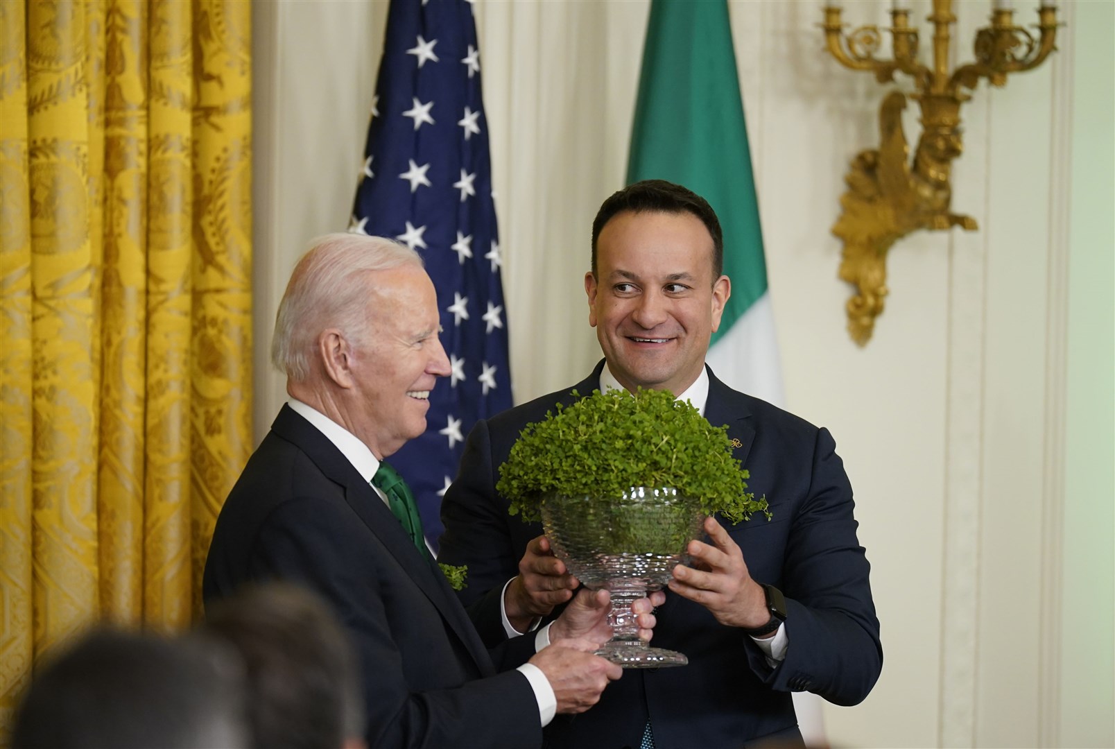 Former taoiseach Leo Varadkar, right, presents then-US president Joe Biden with a bowl of shamrock during the 2023 St Patrick’s Day celebrations (Niall Carson/PA)