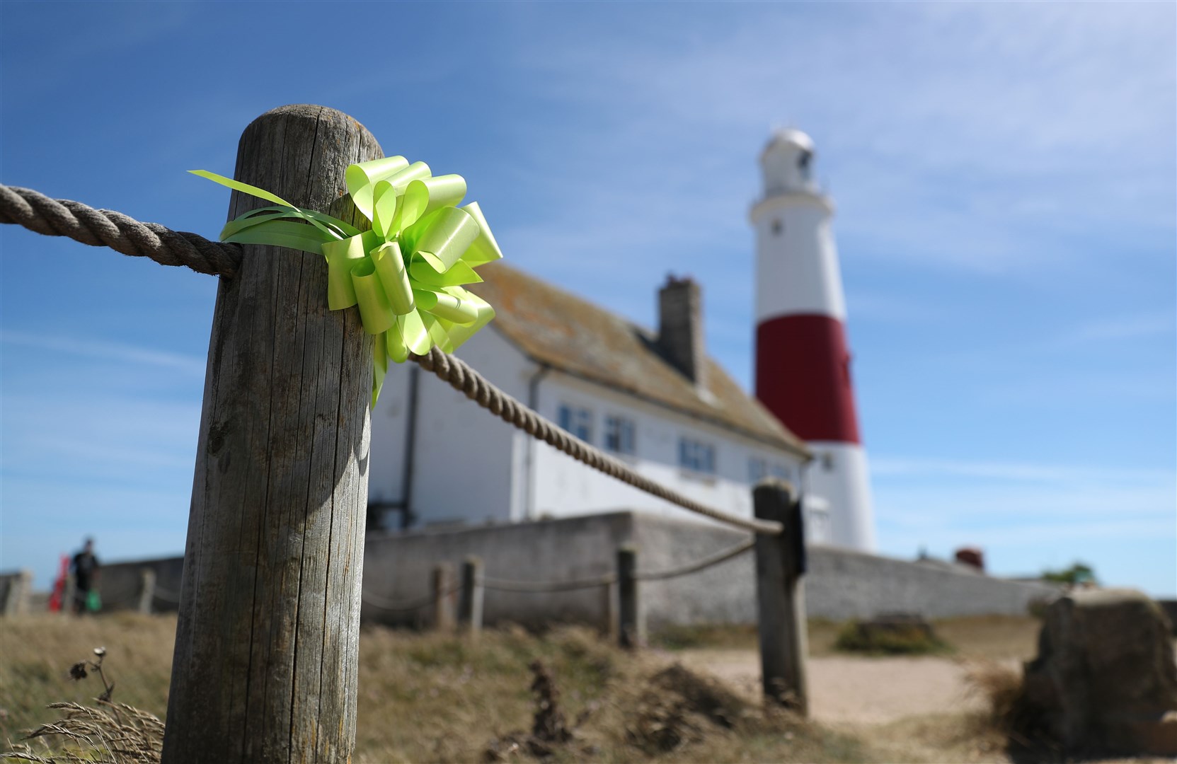 A green justice for Harry ribbon is tied to a post near to Portland Bill lighthouse, where friends and family gathered to scatter his ashes (Andrew Matthews/PA)