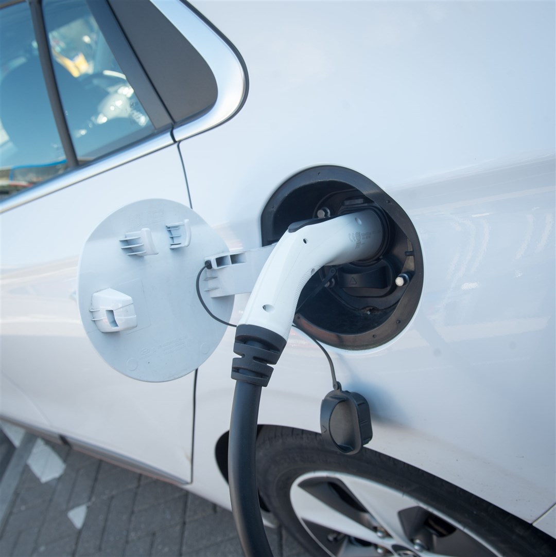 An electric car at a charging point in the Highlands.