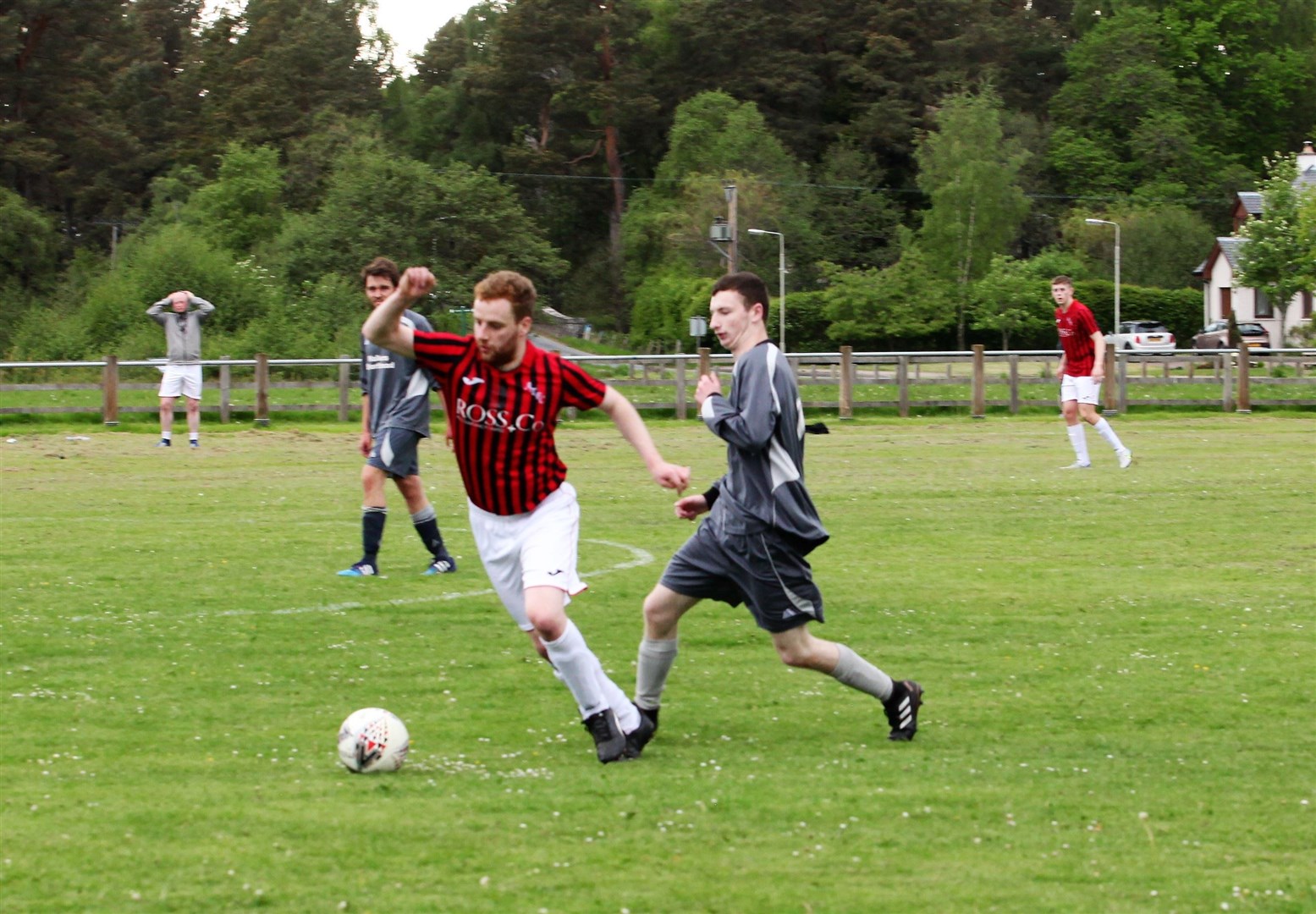 Aviemore goalscorer Finlay McDonald gets away from Abernethy's Matt McHendry.