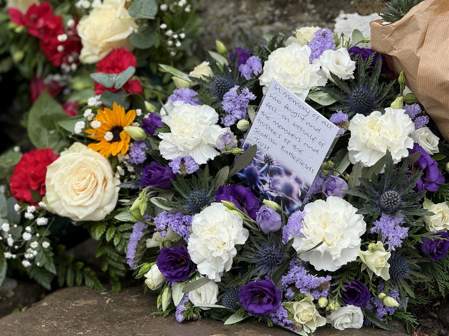 Some of the colourful and beautiful tributes left at the cairn on the day.