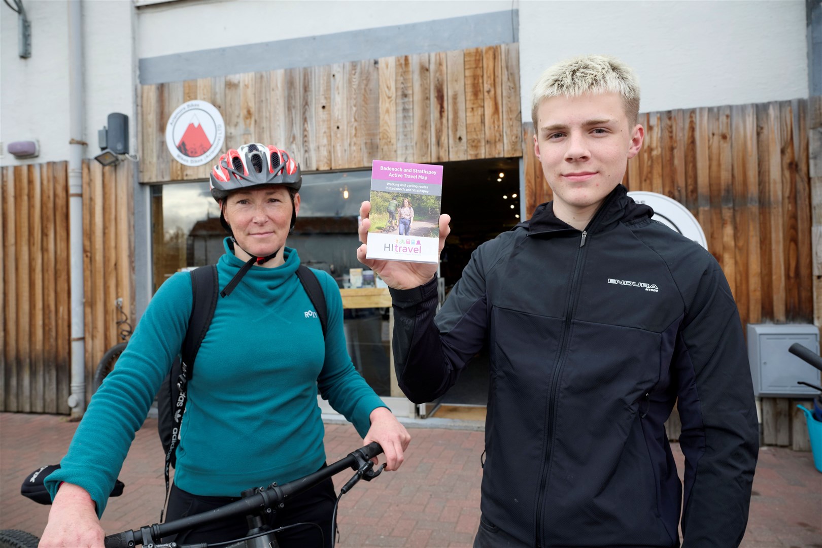 Sheena Corcoran, HITRANS’ smart travel choices promotion and marketing officer, with Sandy Masson, from Mikes Bikes in Aviemore, with the travel map.