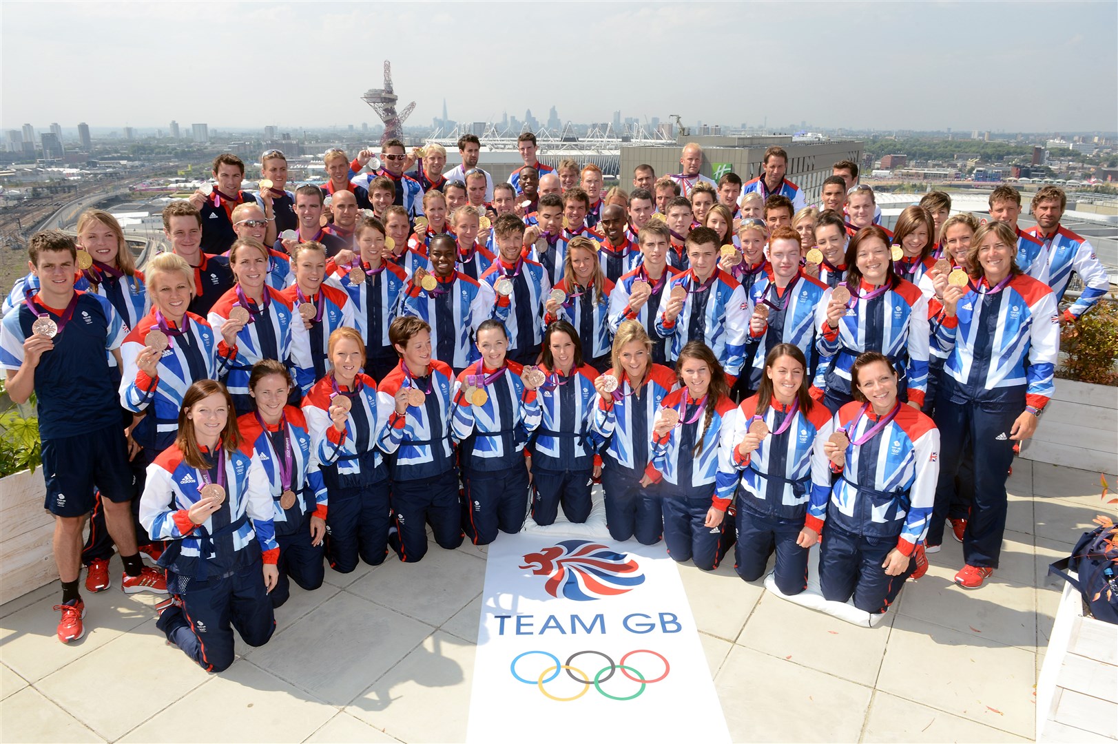 Team GB athletes with their medals after the London 2012 Olympics (Anthony Devlin/PA)