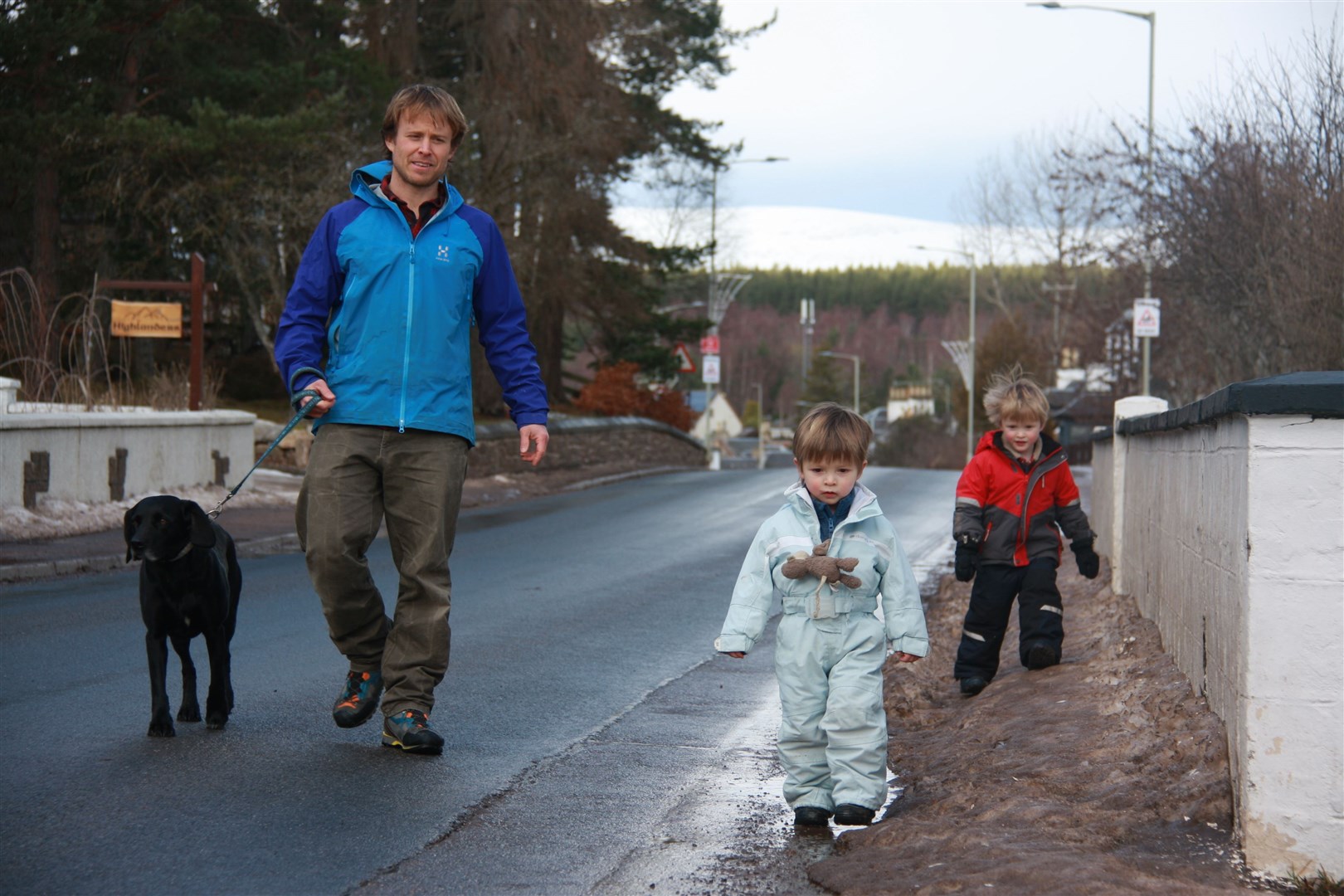 James Bracher with sons Calum (3) and Finn (5), navigating one of the narrow sections of pavement on Main Road in Carrbridge. Photo: Jayne Clark