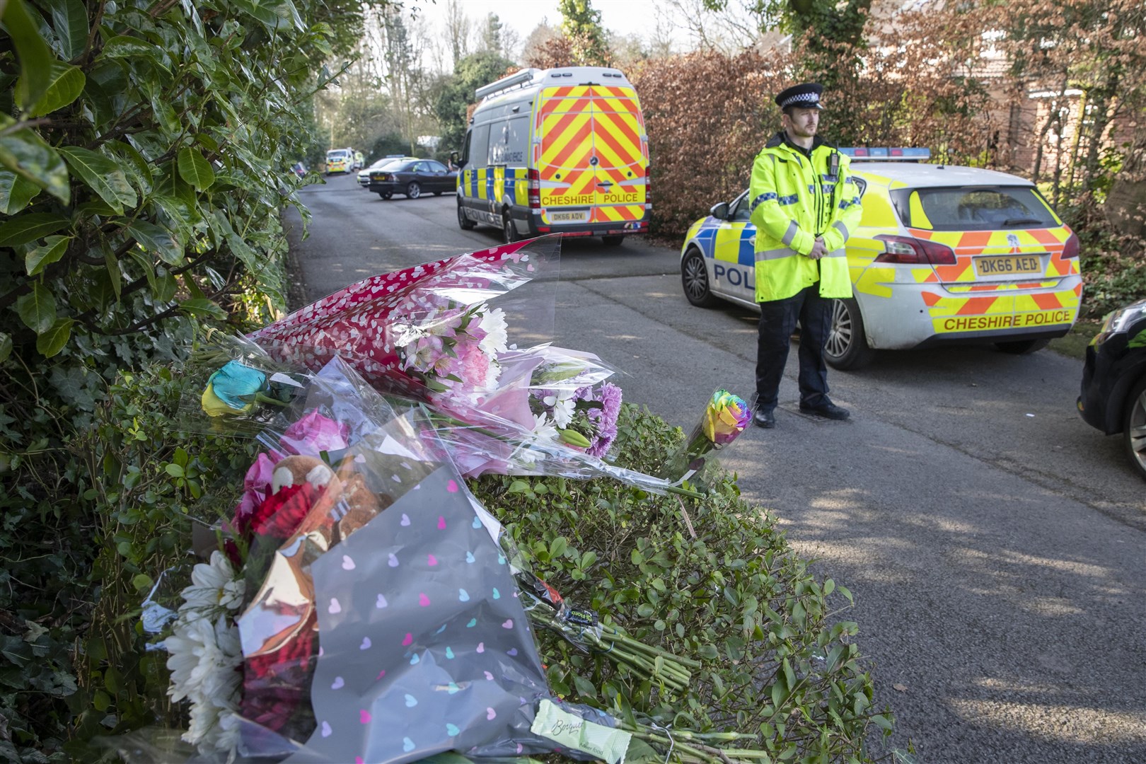 Floral tributes left at the scene in Culcheth Linear Park (Jason Roberts/PA)