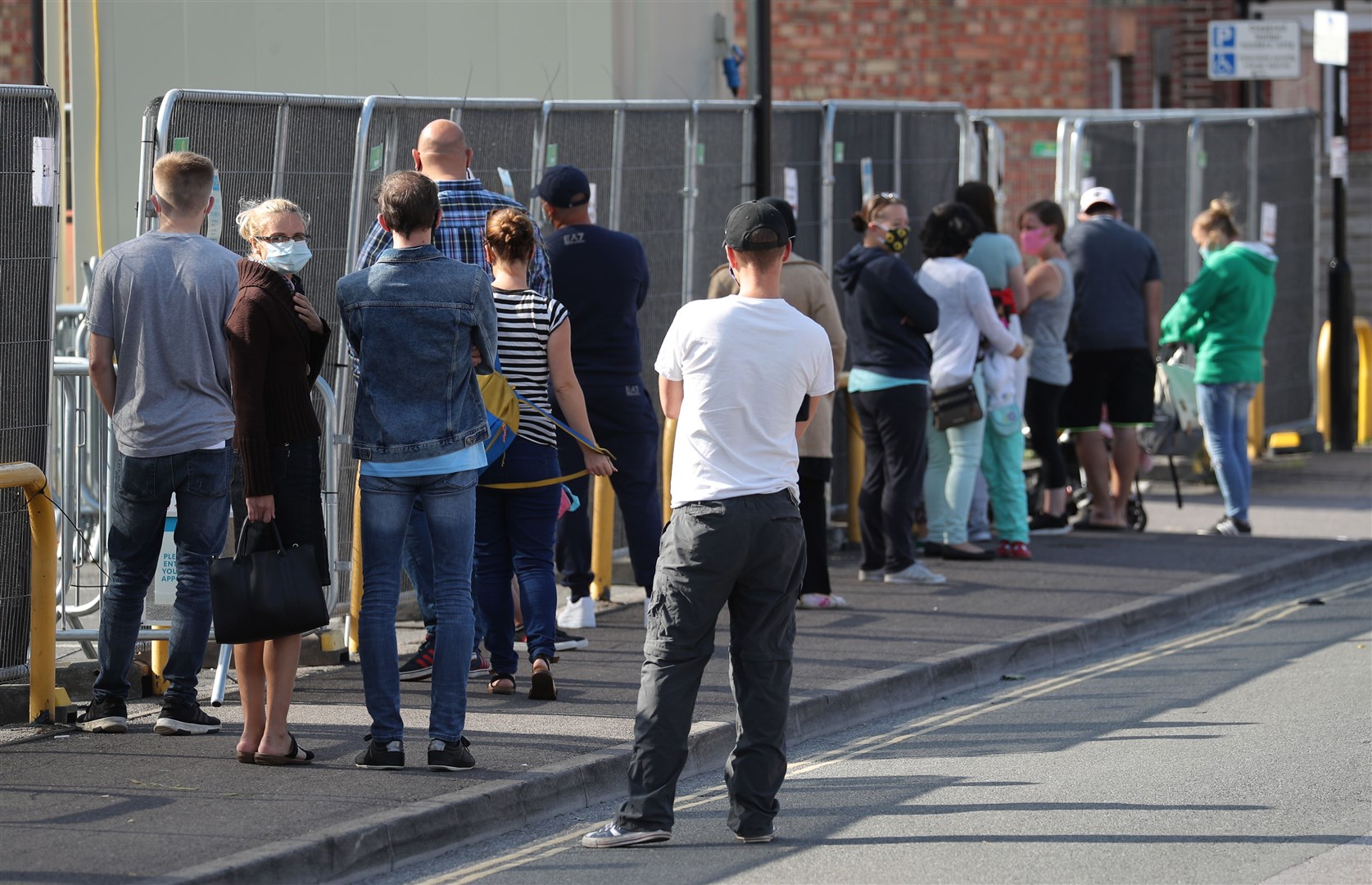 People queue at a walk-through coronavirus testing centre in Southampton (Andrew Matthews/PA)