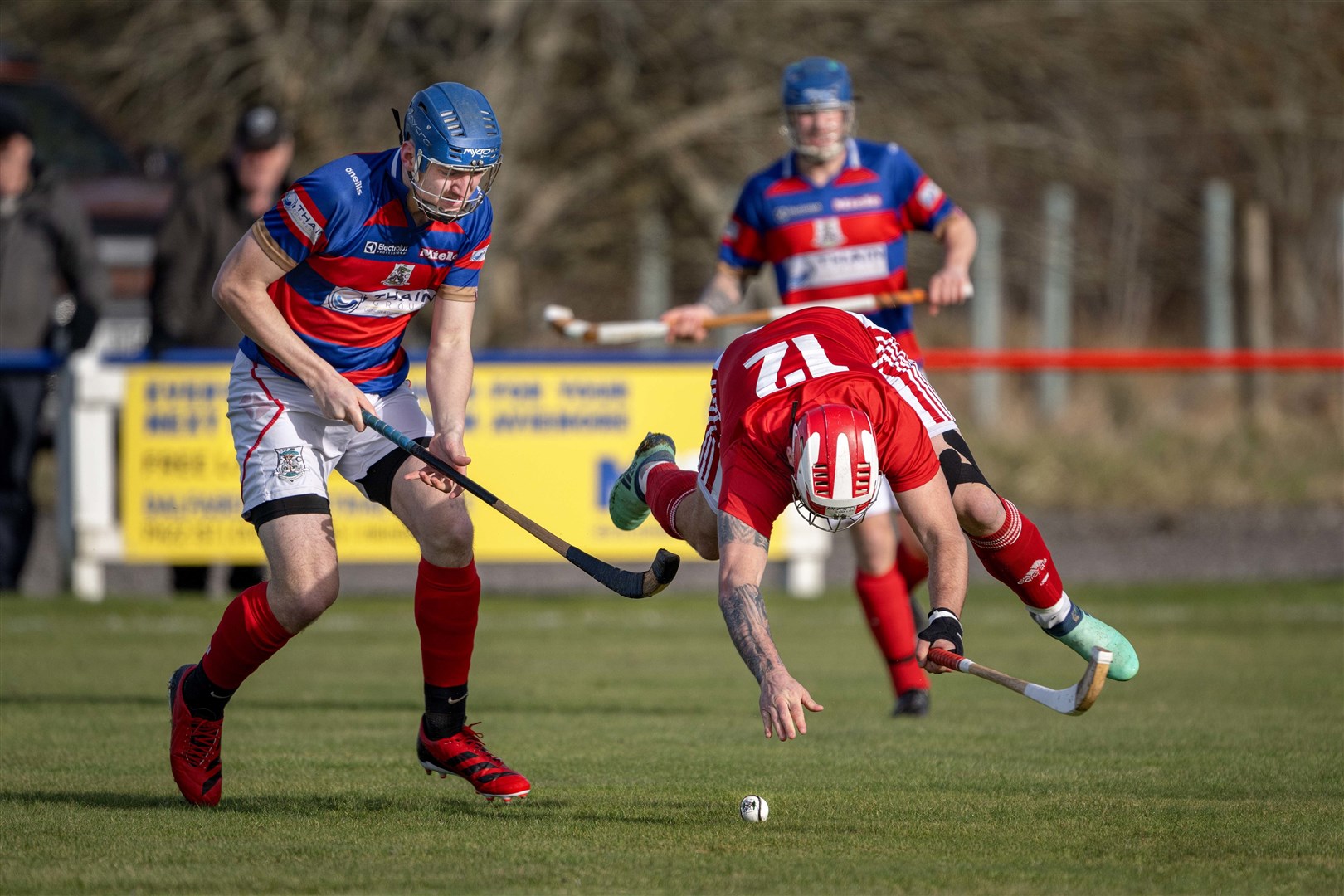 Kinlochshiel's John MacRae gets a nudge from Robert Mabon (Kingussie). Kingussie v Kinlochshiel in the Mowi Premiership, played at The Dell, Kingussie.