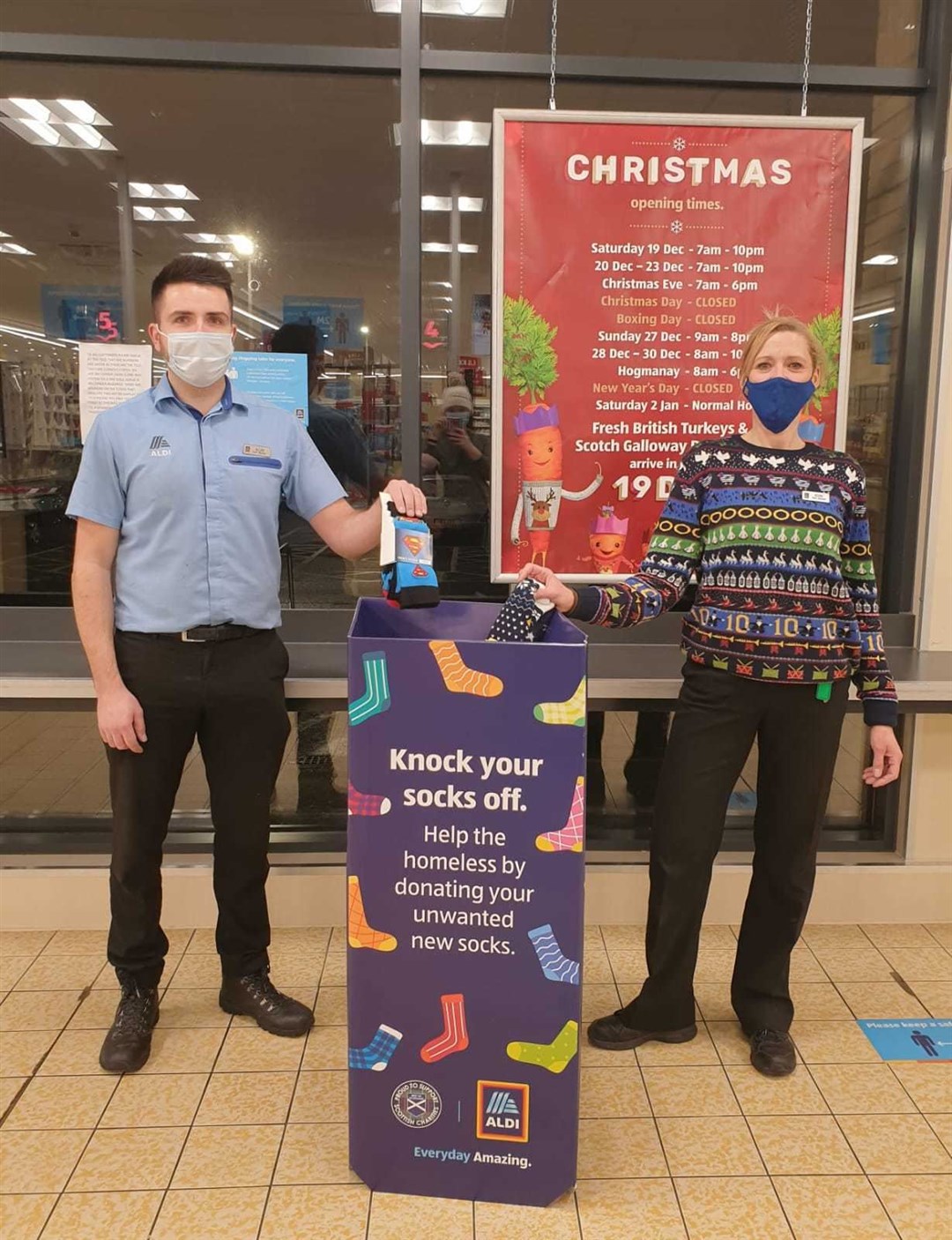 Sock it to us! Allan Jenkins and Kerry MacLeod are among the Aldi staff administering the sock amnesty