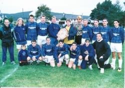 Aviemore United receive the Badenoch and Strathspey Welfare League Shield from Graeme Mackie in September 1997. Pictured are (back l to r:) Dougie Somerville, Noel Baxter, George McIlroy, Jerry Wright, James Brannan (capt), Craig Hyatt, David Robertson, S