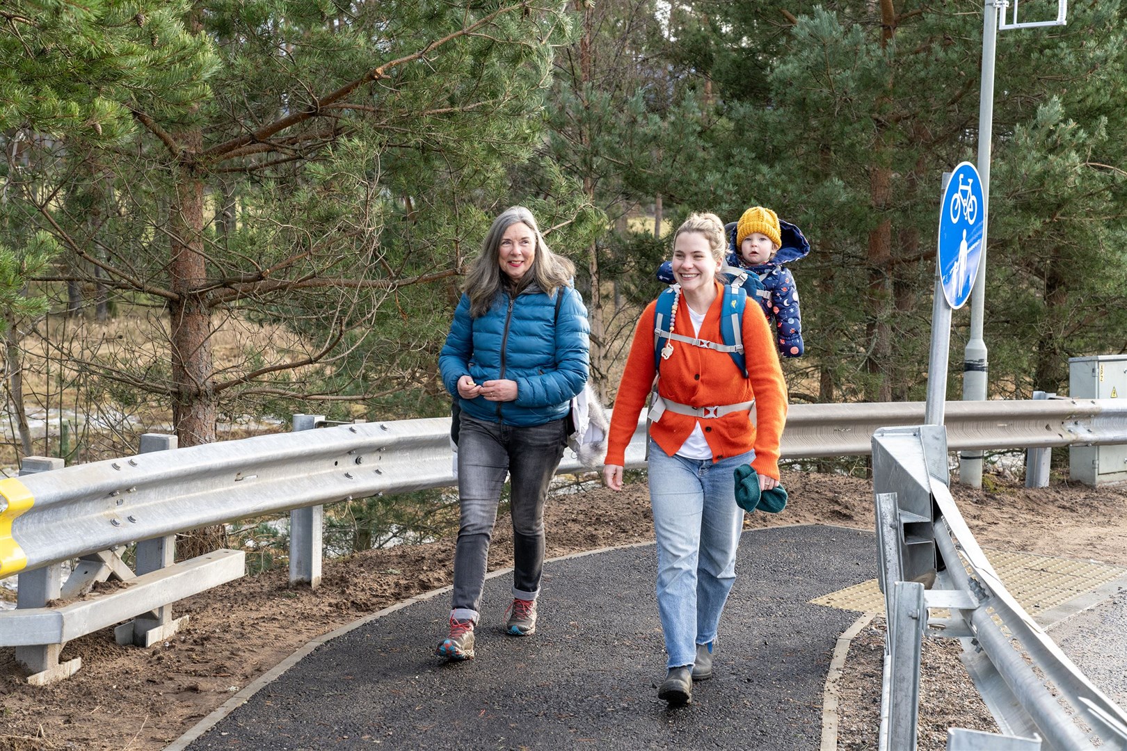 Little Ailbhe Blackman enjoys his piggy-back ride on mum Opehlia as he becomes the first official walker to use the new section, during a stay with grannie Mags at Insh. Pictures by Keith Ringland