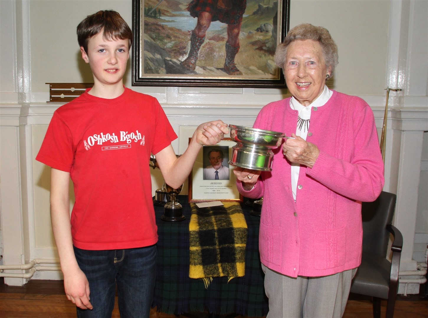 Young Elijah receives one of his three trophies from Margaret Redden.