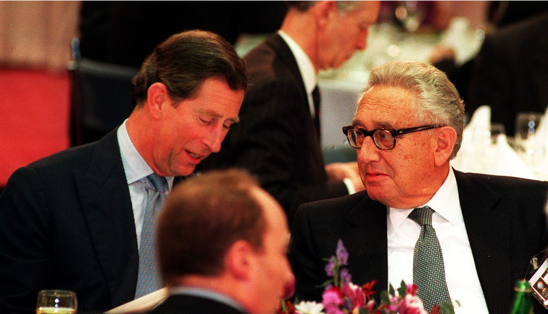 The King, who was then the Prince of Wales, talking with Mr Kissinger during a conference at the Royal Institute of International Affairs in March 1995 (PA)