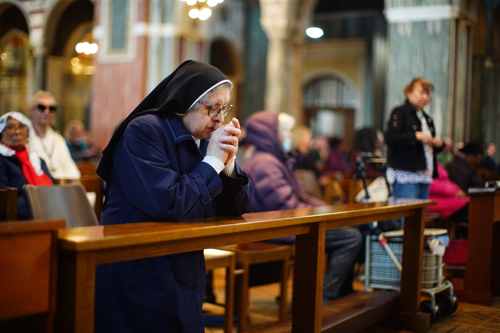 A nun prays in Westminster Cathedral following the announcement by the Vatican of the death of Pope Francis (PA/James Manning)