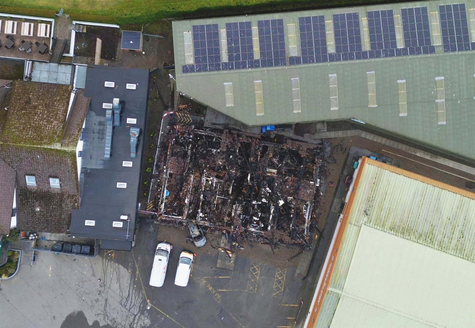 Drone footage reveals the scale of the damage and how close it came to neighbouring buildings. Picture: Walter Geddes.