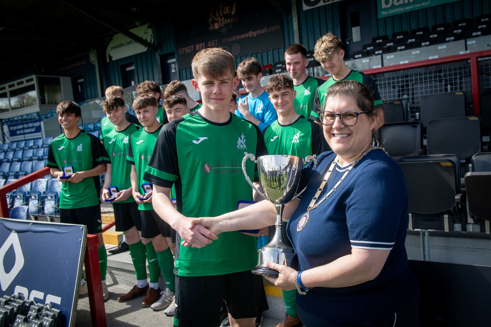 The North of Scotland schoolboys team captain Craig Lawrie is presented with the National Cup. Picture: Callum Mackay