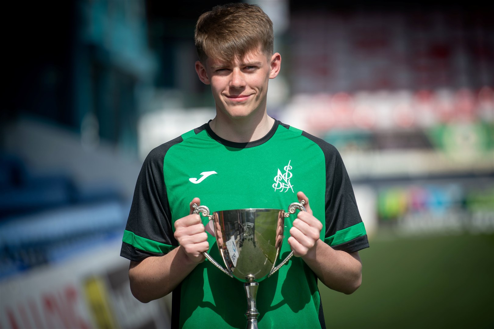 Dingwall Academy pupil and North of Scotland team captain Craig Lawrie with the National Cup. Picture: Callum Mackay