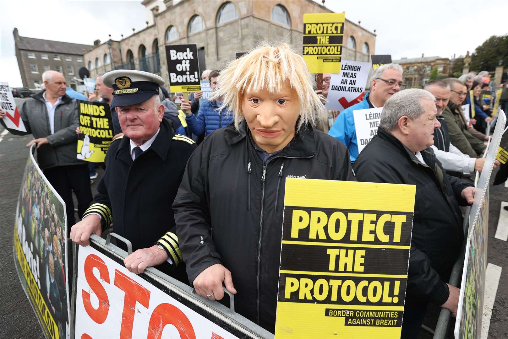 A man dressed as a customs officer and another dressed as Boris Johnson with protesters from Border Communities Against Brexit outside Hillsborough Castle (Liam McBurney/PA)