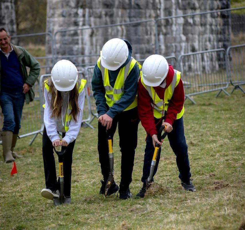 Pupils from Strathdearn Primary School officially break ground on the site, which is next to the railway viaduct at the northern end of Tomatin.