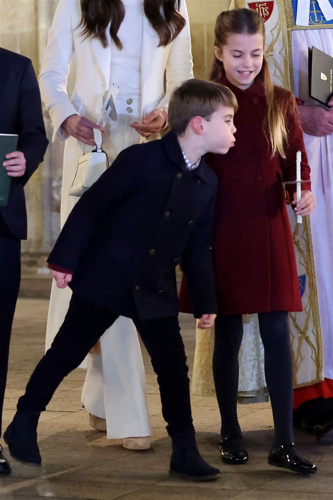 Prince Louis blows out a candle held by Princess Charlotte (Chris Jackson/PA)
